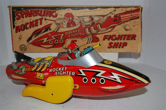 Marx Sparkling Rocket fighter ship tin windup toy, new in the box, rated 9.75, $715. Image courtesy of Matthews Auctions LLC.